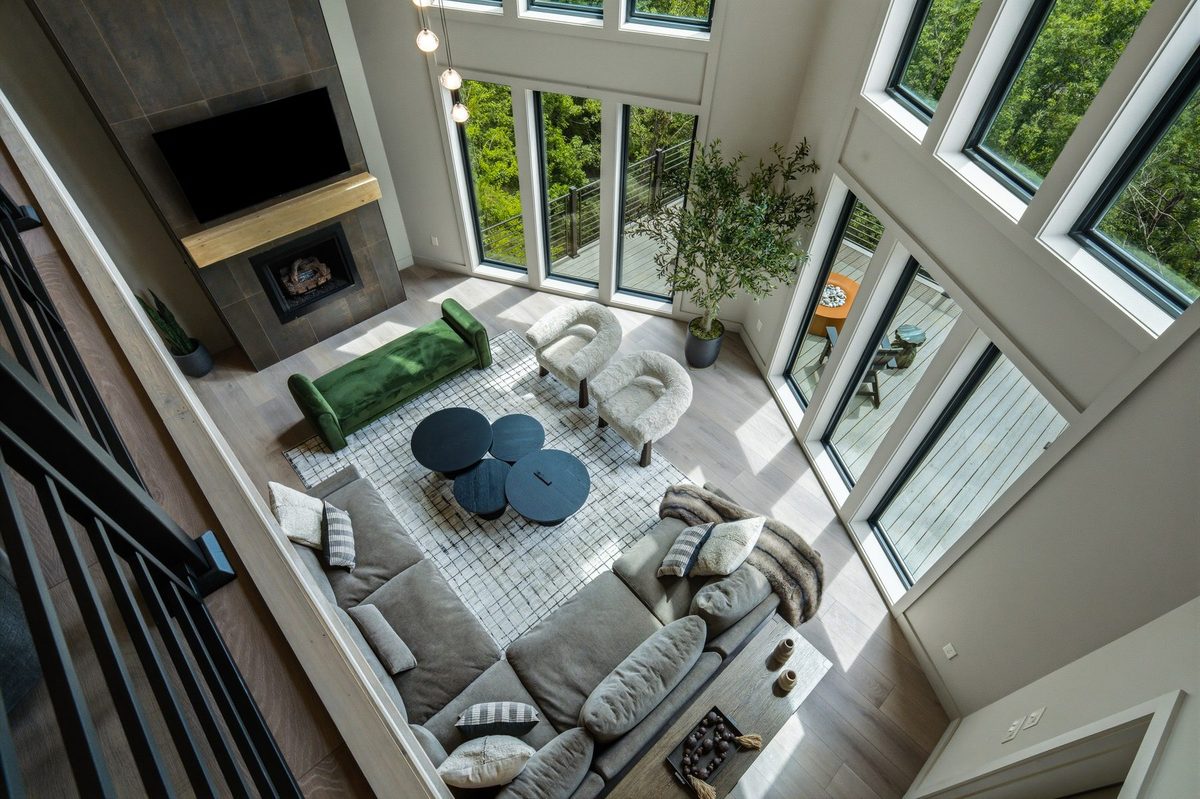 Great room with fireplace and window wall viewed from the upper level at 1813 Red Bone Way, Sevierville TN