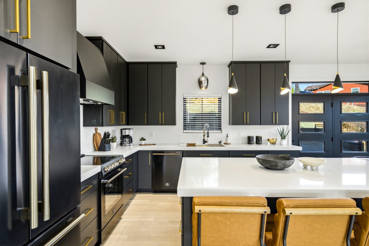 Kitchen with black cabinets, brass hardware and white island at 550 Greenbriar Ln, Gatlinburg TN