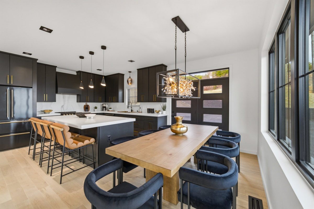 Dining table with navy chairs open to the kitchen at 550 Greenbriar Ln, Gatlinburg TN