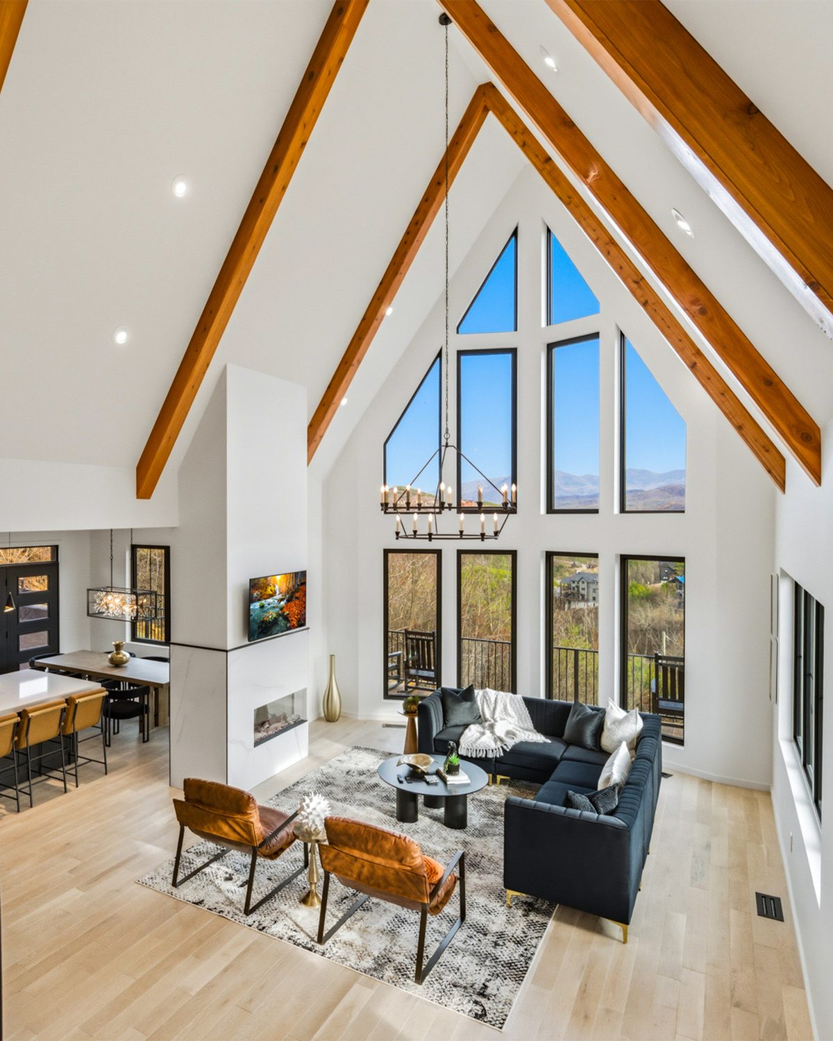 Vaulted great room with timber beams and mountain view windows at 550 Greenbriar Ln, Gatlinburg TN