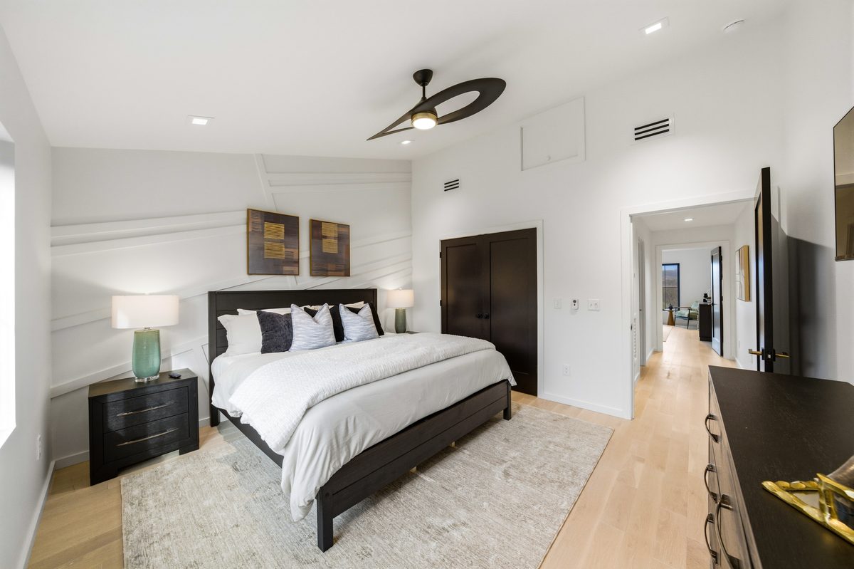 Bedroom with white walls, dark wood bed and hallway view at 550 Greenbriar Ln, Gatlinburg TN