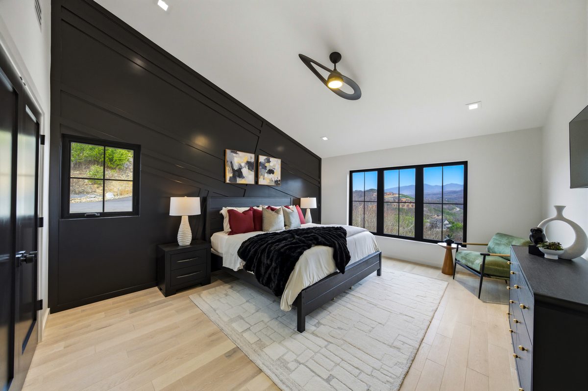 Bedroom with black accent wall and mountain view windows at 550 Greenbriar Ln, Gatlinburg TN